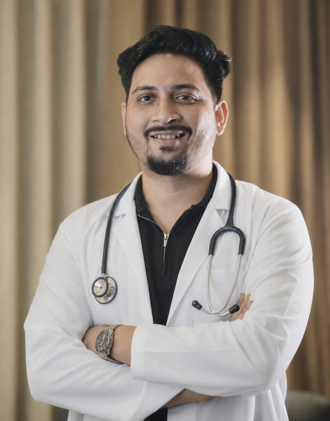 Dr. Gaurav Das in a white coat with a stethoscope, smiling