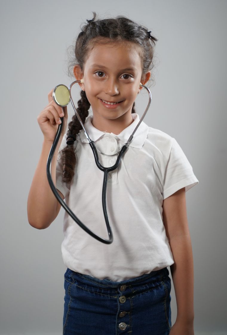 A girl with a plait holding a stethoscope